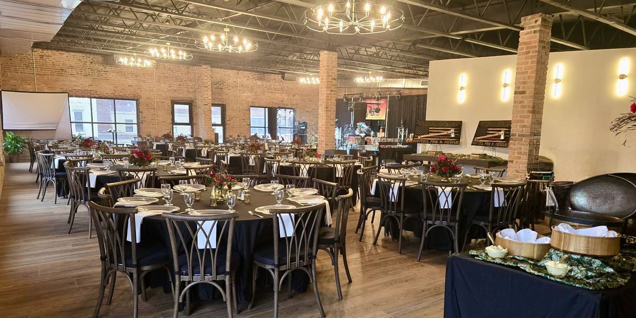 Elegant banquet hall with round tables set for an event.