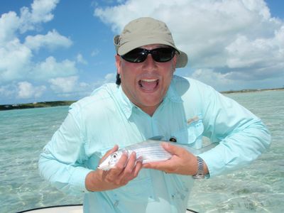 happy man holding a fish in hands