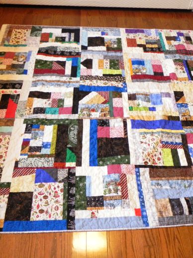 Colorful patchwork quilt with a variety of patterned fabric squares.