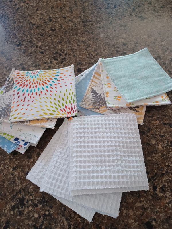 Colorful and white fabric squares on a kitchen countertop.