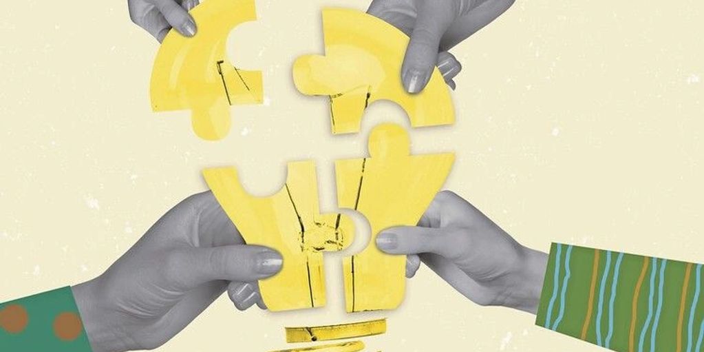 Hands assembling yellow jigsaw puzzle pieces forming a lightbulb shape.