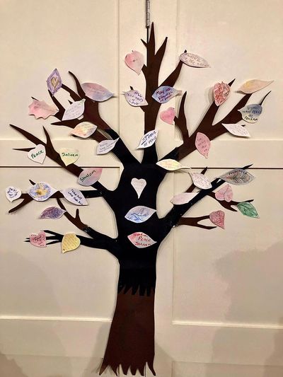 Tree with paper leaves giving messages of peace
