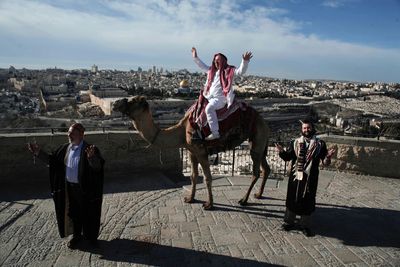 Middle East partners on the Mount of Olives, with one of them sitting on a camel