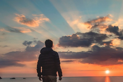 Person looking at the sunrise