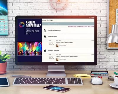 A large computer screen with a virtual conference on the screen that says Annual conference Virtual 