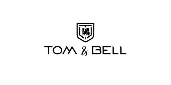 Minimalist black and white logo for Tom &amp; Bell with a shield emblem.