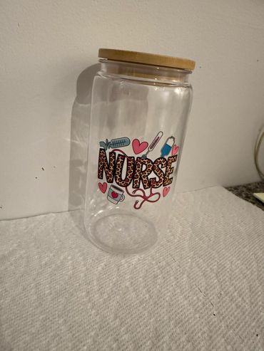 Clear jar with nurse-themed design and wooden lid.