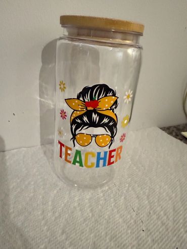 Clear jar with teacher-themed design and wooden lid.