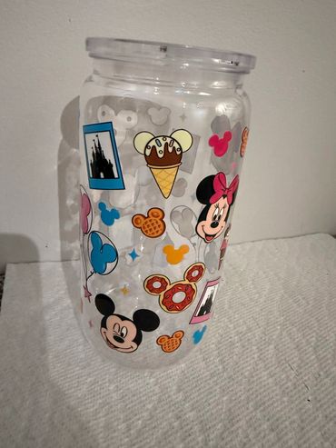 Clear jar decorated with colorful Disney-themed stickers featuring Mickey and Minnie Mouse.