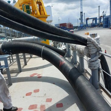 Industrial hoses by Limusnunggal Rubber at a port designed for reliable heavy-duty fluid transfer