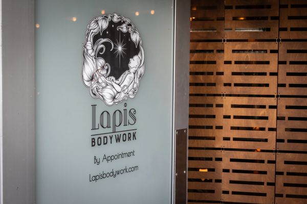 Sign for Lapis Bodywork with artistic design.