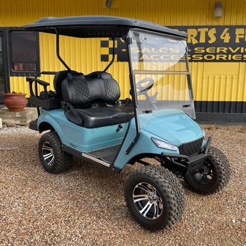 A 2016 EZGO TXT with a MadJax Storm body kit with a 6in axle lift and a long top.