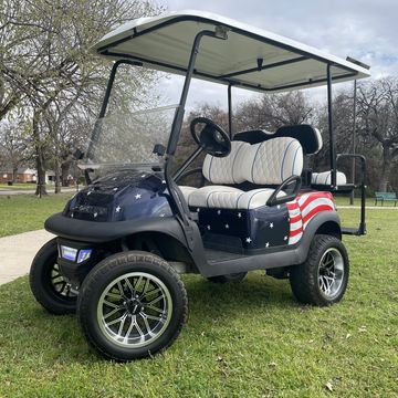An American Flag custom painted Club Car Tempo with 14in wheels and custom white seats.