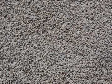 Close-up of small grey gravel stones covering the ground.
