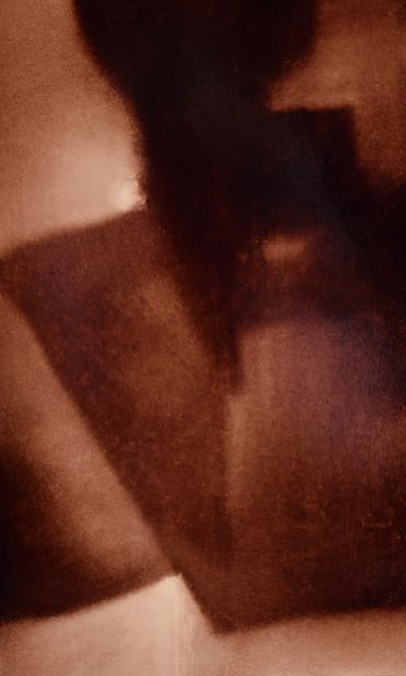 Abstract shadow and light shapes in warm brown hues.