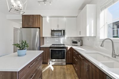 Modern kitchen with white and wooden cabinetry.
