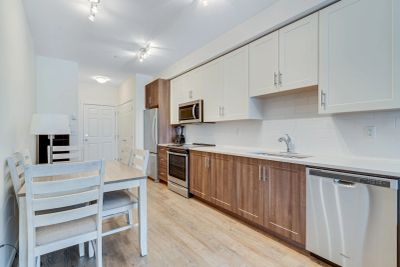 Modern kitchen with wooden and white cabinets.