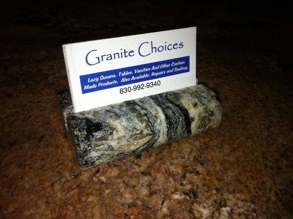 Granite card holder with business card on a granite surface.