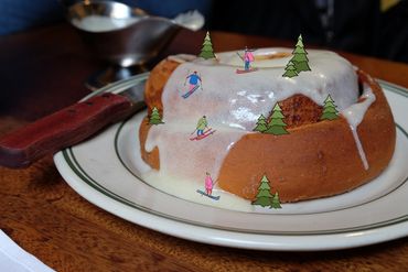 Bundt cake with ski-themed decorations on icing.