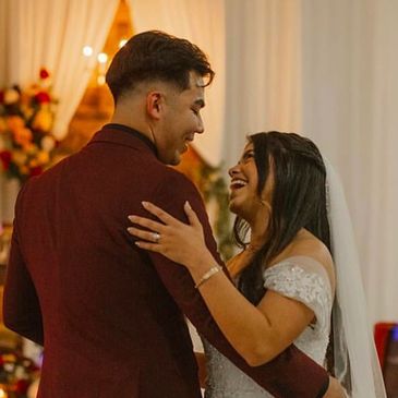 Bride and groom sharing a joyful dance at their wedding.