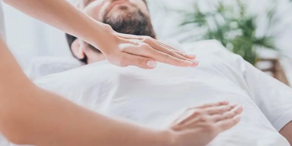 woman hands hovering above man laying down