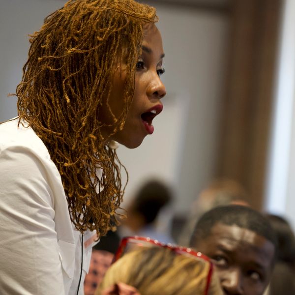 Woman speaking with expression of surprise or emphasis.