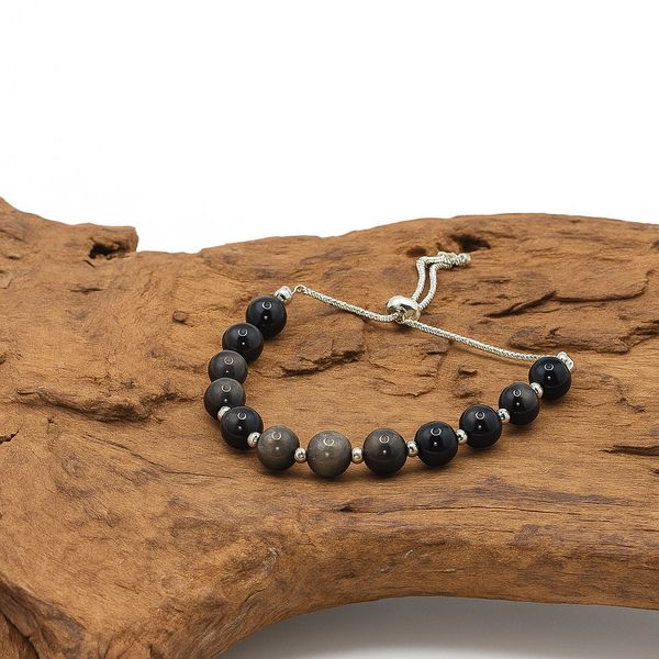 Black and gray bead bracelet on wood.