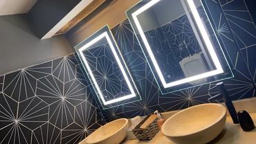 Two glowing LED bathroom mirrors.
