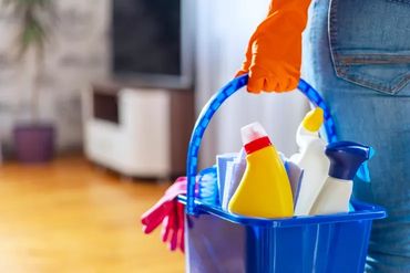 Cleaning supplies in blue bucket.
