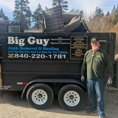 Junk Removal Trailer 
Tall man 
Junk in the trailer