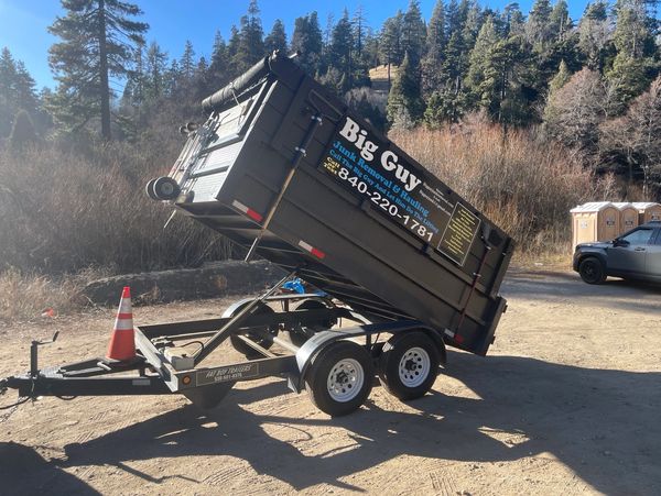 Big Guy Junk Removal trailer unloading debris in Crestline, CA. 