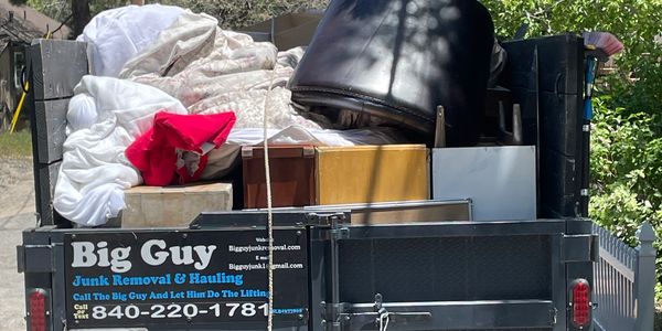 alt="Residential backyard junk removal service with household debris and clutter"
