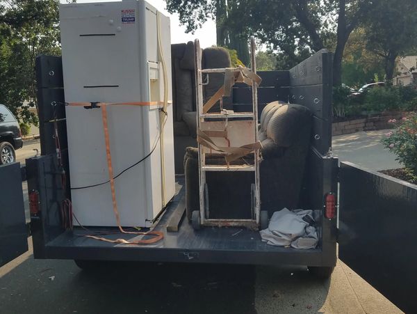 alt="Appliance removal service hauling refrigerator and household junk in San Bernardino, CA