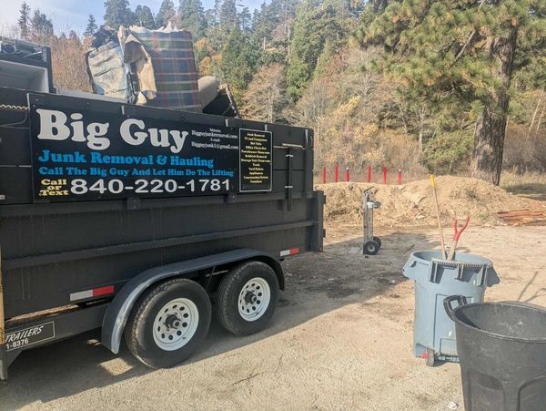 alt="Big Guy Junk Removal trailer providing junk hauling service in San Bernardino communities"
