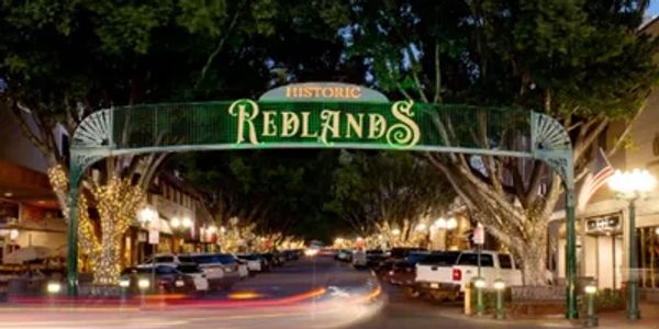 alt="Historic Redlands sign in downtown Redlands CA at night"
