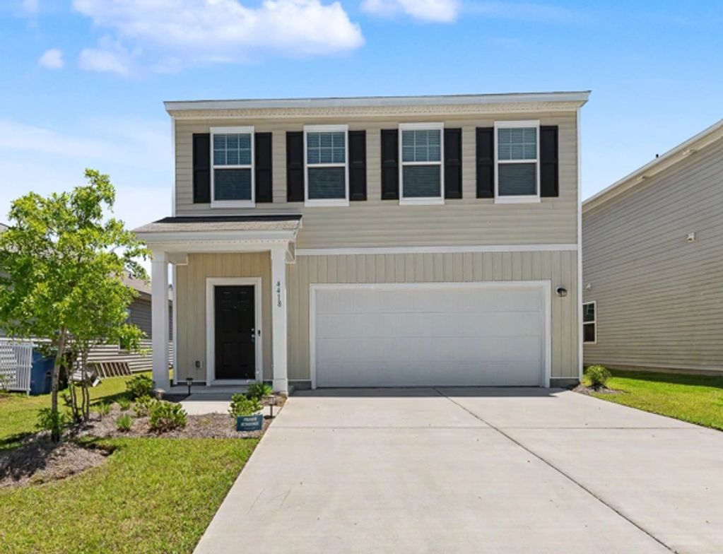 Modern two-story house with beige siding and black shutters.