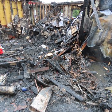 Charred remains and debris after a house fire.