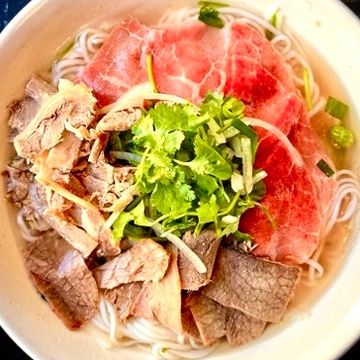 Undercooked eye-round beef steak and flank pho