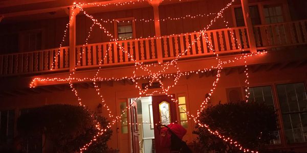 Halloween lights in the shape of a spiders web. Orange Christas lights used.