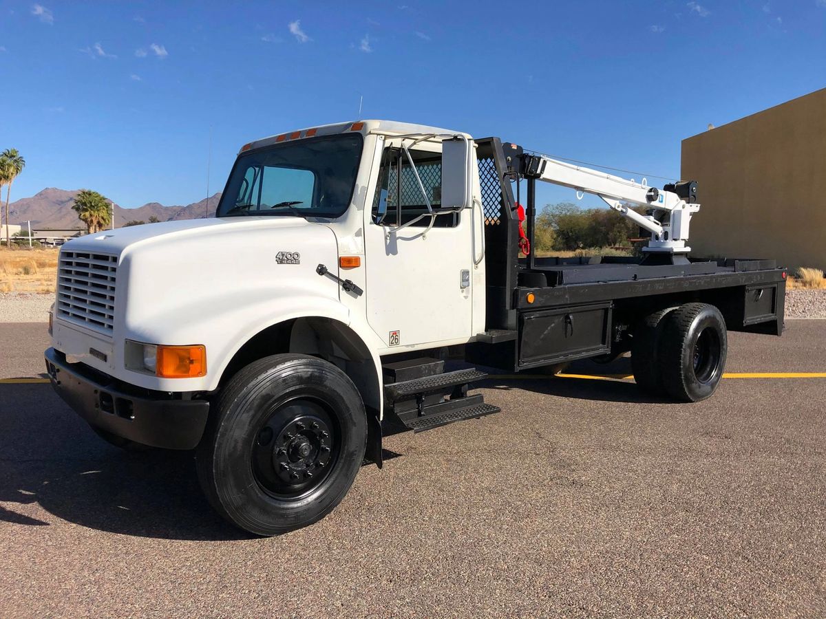 SOLD 2001 International 4700 FLATBED 94K MILES FLATBED CRANE TRUCK