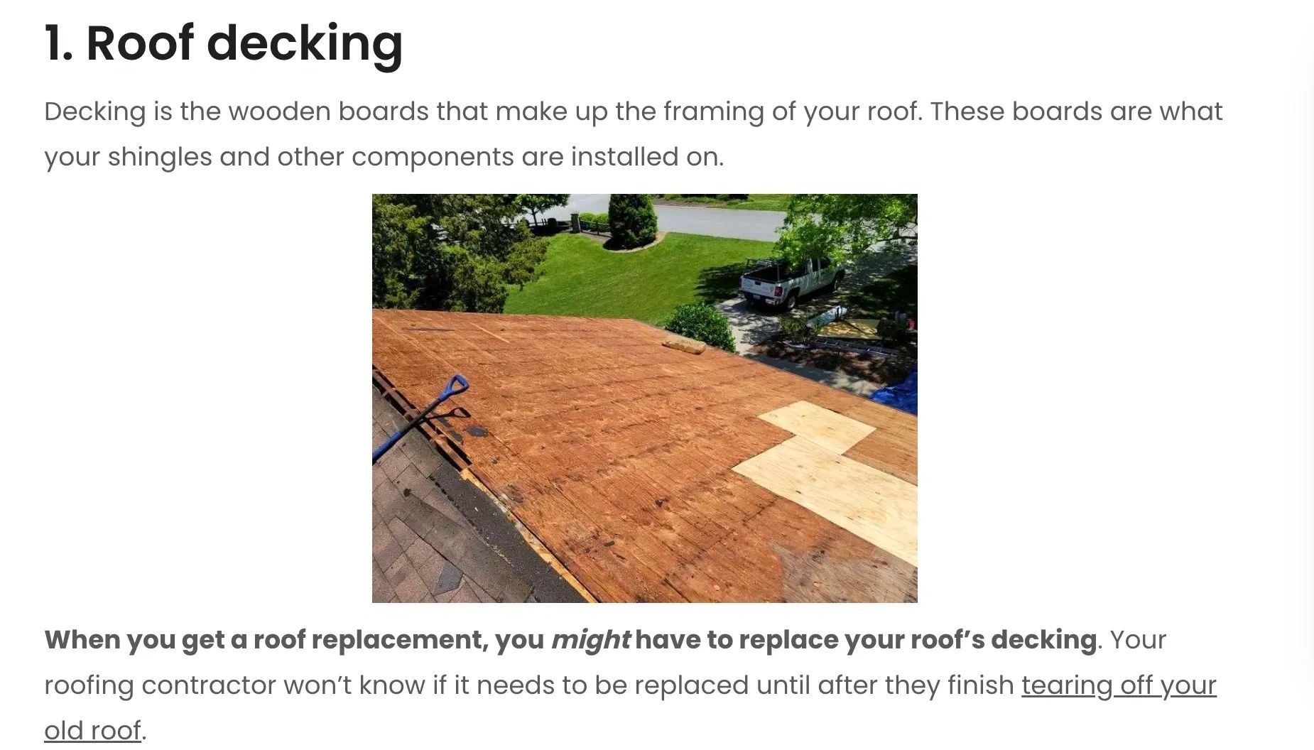 Roof with wooden decking boards during replacement.