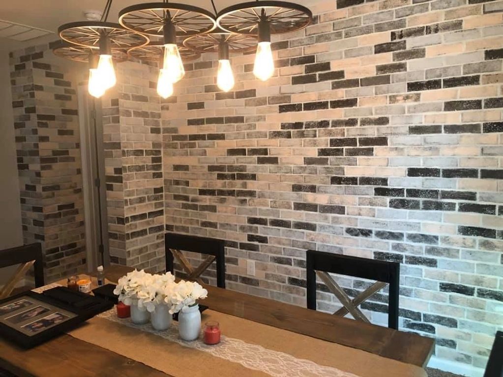 This dining space invites you in with the bricks painted directly on the drywall 
