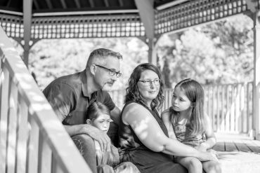 Black and white photo of a family sitting together.