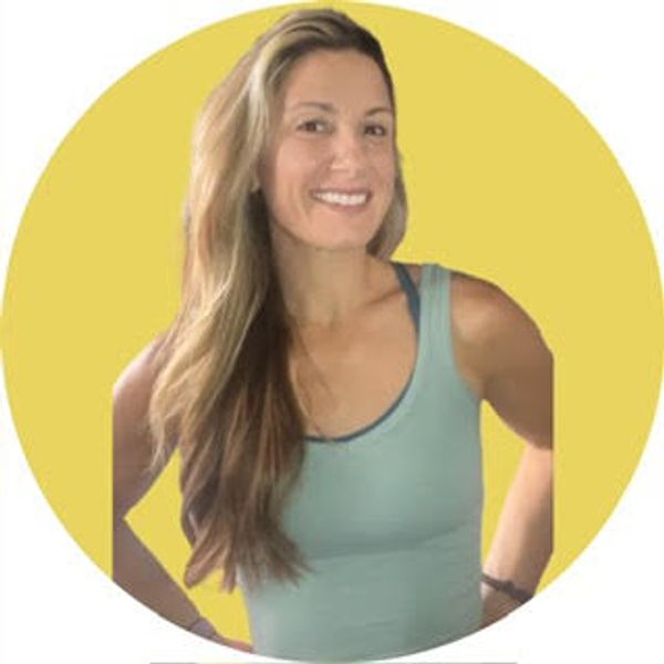 Smiling woman with long hair in a teal tank top against a yellow background.