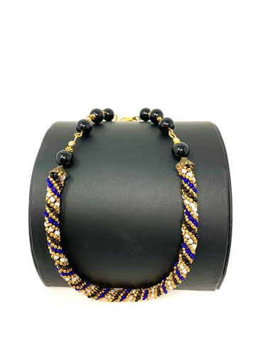 A Necklace With Purple and Gold Beads