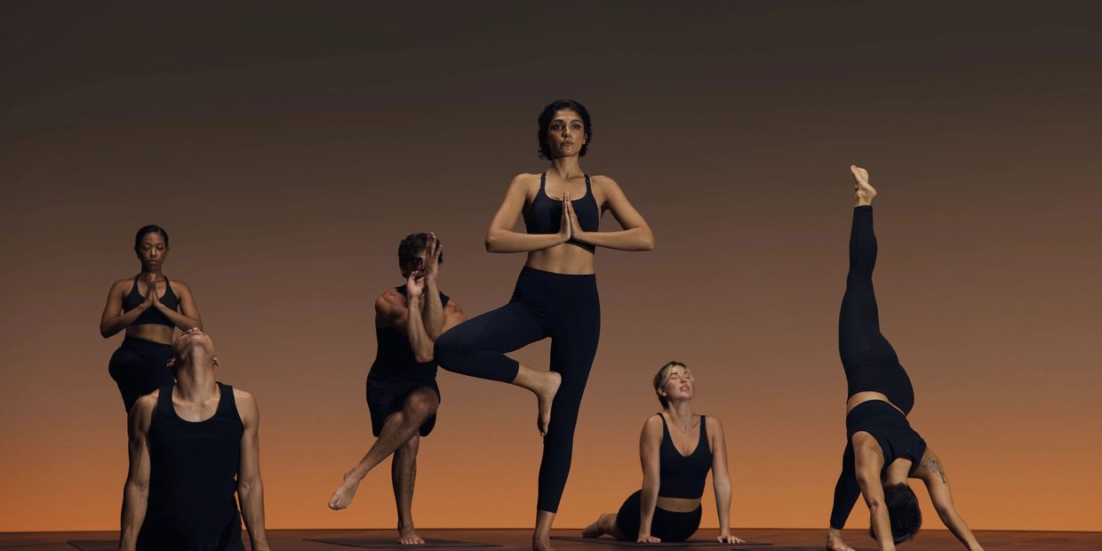 Group of people performing yoga poses in a calm environment.