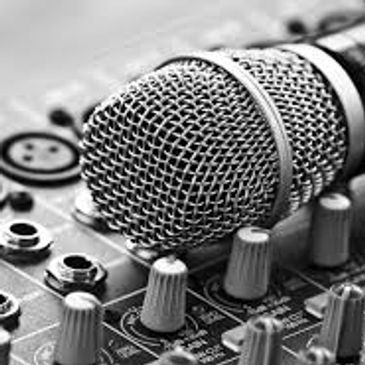 Close-up of a microphone on an audio mixing console.