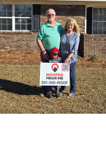 Satisfied customers holding a roofing sign
