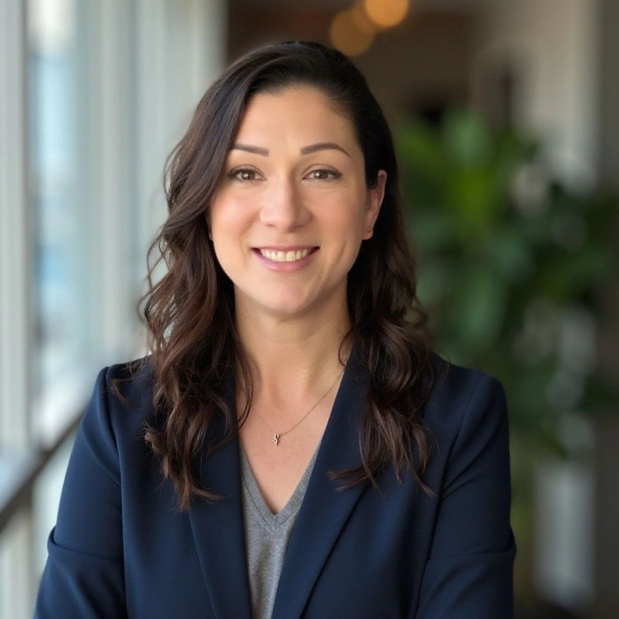 Woman smiling confidently in a business setting.