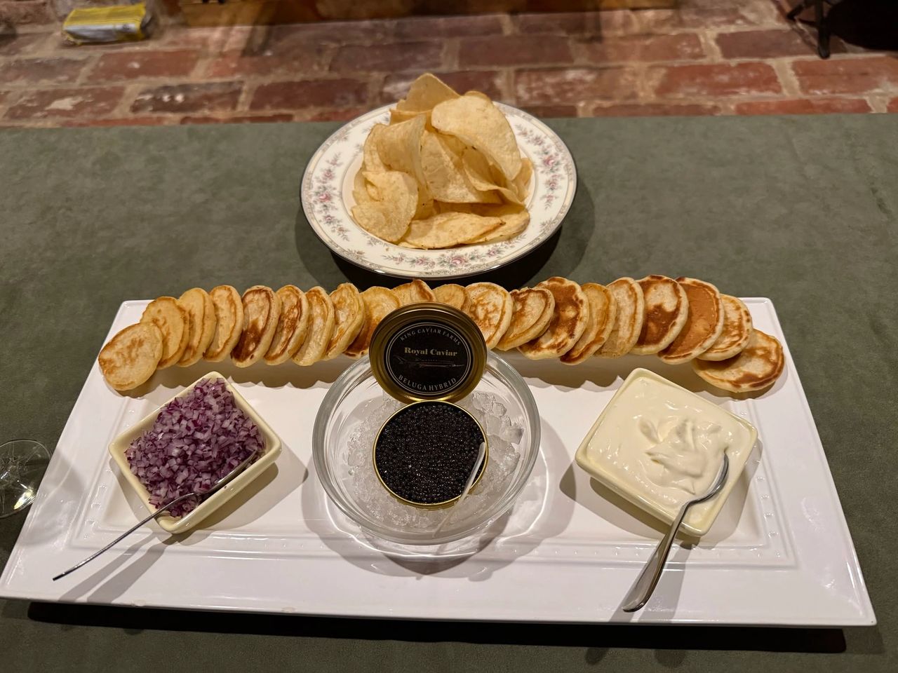 Classic caviar service with blinis crème fraîche and traditional accompaniments